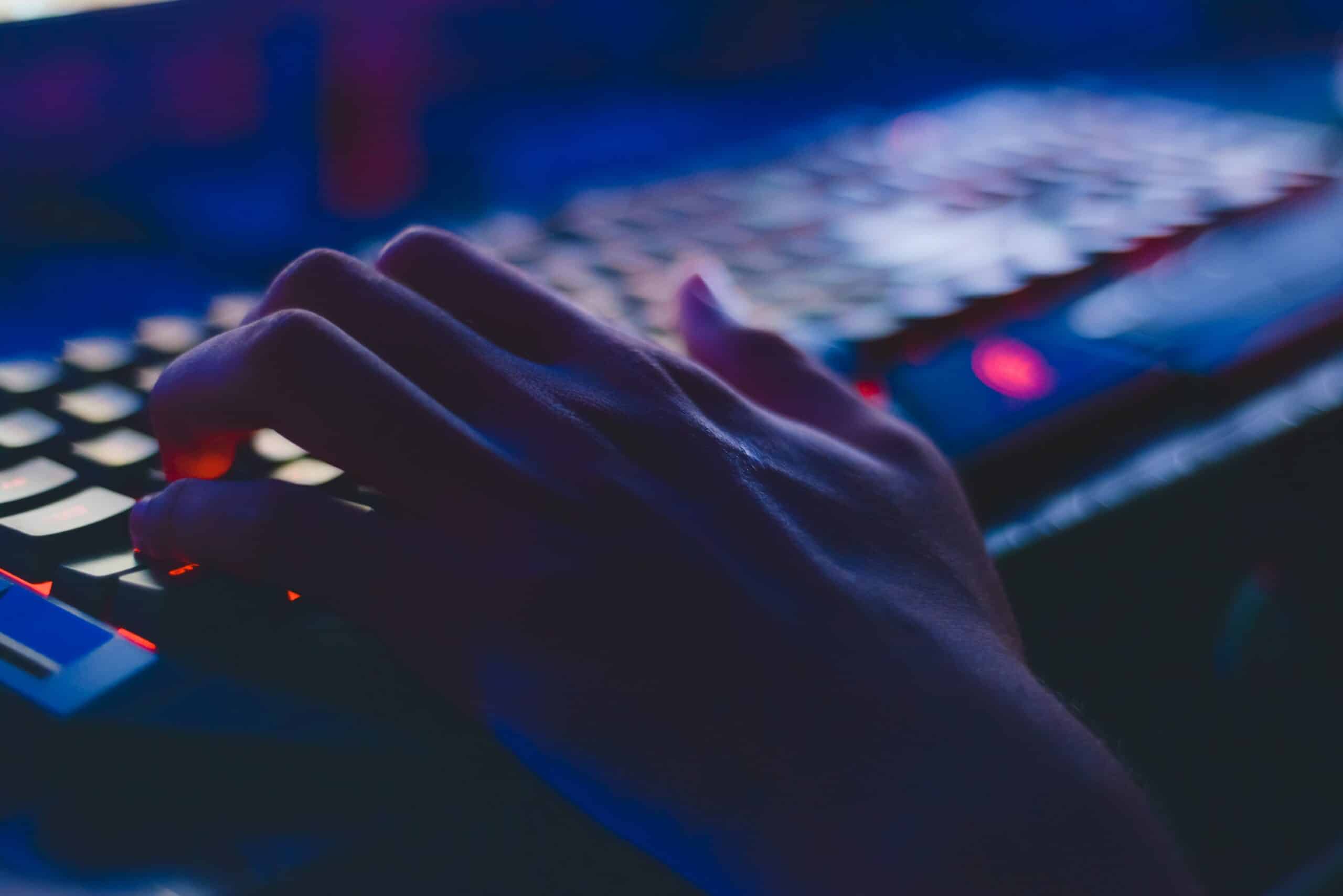 hacker typing in the dark